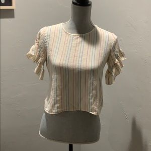 Rainbow lined top with embellished sleeves.